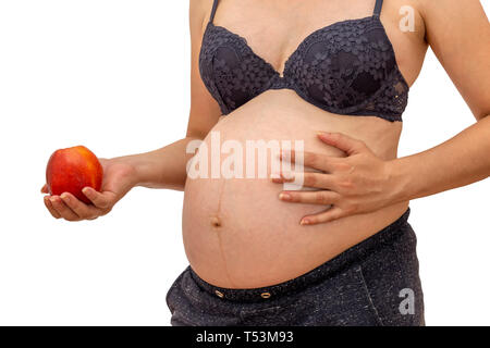 Pregnant woman holding an red apple. Healthy pregnancy and nutrition during pregnancy with apple, isolated on white. Stock Photo