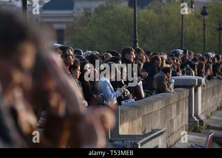 *** FRANCE OUT / STRICTLY NO SALES TO FRENCH MEDIA *** April 15, 2019 - Paris, France: A crowd watch as a large fire burns in Notre Dame cathedral of Paris. Stock Photo