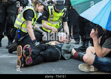 London UK 18th Apr 2019 Police officers prepare to remove protesters with a tube connecting them during protest by Environmentalists. Stock Photo