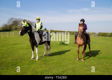 Kent. UK. Two horse riders going for a hack in the countryside on a lovely sunny day. Stock Photo