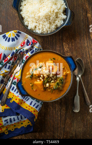 African chicken peanut stew with sweet potatoes and okra with side of basmati rice Stock Photo