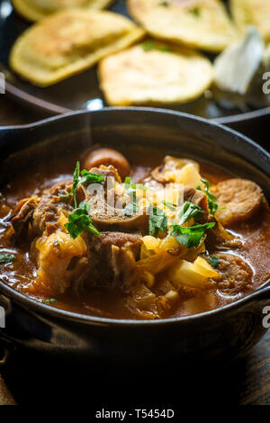 Polish hunters stew known as Bigos with pork loin sausage and lamb neck Stock Photo