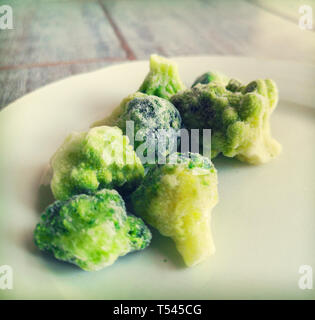 frosted broccoli frozen veggies icing in freezer fridge Stock Photo