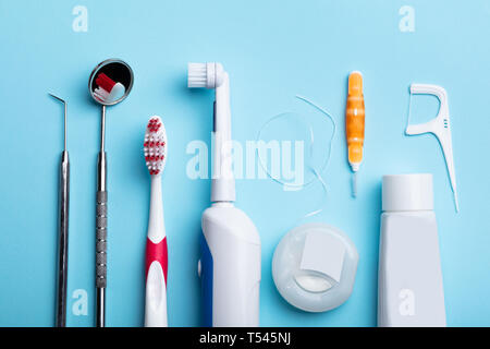 An Elevated View Of Dental Instrument On Blue Surface Stock Photo