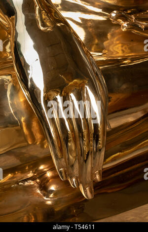 Thailand, Bangkok, Thanon Bamrung Mueang, Soi Mahannop2, Buddhist Supplies Shop, hand of large polished metal Buddha for sale touching ground in Bhumi Stock Photo