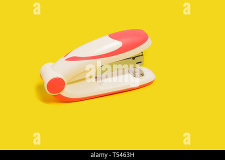 stapler on a yellow background Stock Photo