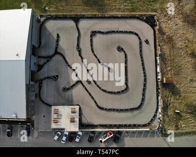 KIELCE, POLAND - APRIL 17 2019 Editorial aerial image of outdoor go kart racetrack made of tyres. People driving professional go carts. Stock Photo