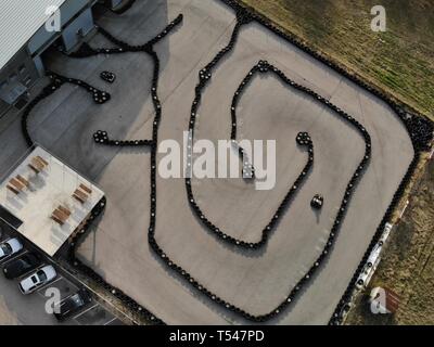 KIELCE, POLAND - APRIL 17 2019 Editorial aerial image of outdoor go kart racetrack made of tyres. People driving professional go carts. Stock Photo