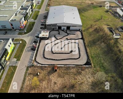 KIELCE, POLAND - APRIL 17 2019 Editorial aerial image of outdoor go kart racetrack made of tyres. People driving professional go carts. Stock Photo