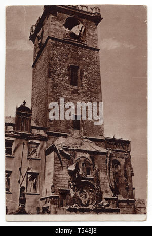 Damages on the medieval tower of the Old Town Hall (Staroměstská radnice) in Old Town Square (Staroměstské náměstí) in Prague, Czechoslovakia, damaged during the Prague Uprising in the last days of World War II in May 1945. Black and white photograph by an unknown photographer taken in May 1945 and issued in the Czechoslovak vintage postcard in 1945. Courtesy of the Azoor Postcard Collection. Stock Photo