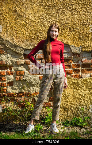 Young hipster girl near old sport car at night city Stock Photo