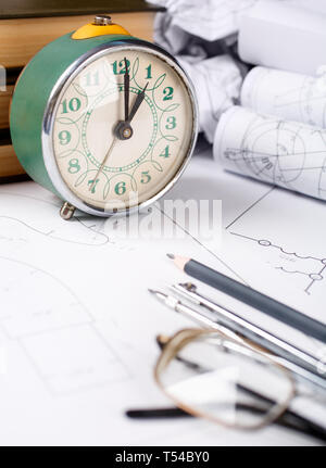 Books on architecture, a few crumpled drawings, glasses on the table in the architect. The set of elements reflecting the concept of engineering and d Stock Photo