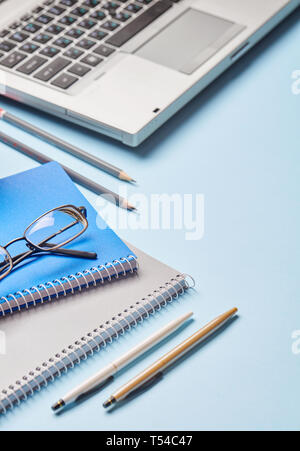 Workplace of the secretary - notebook, pen, sharpener and loptop. Group of school supplies on table Stock Photo