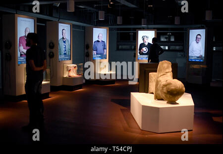 Berlin, Germany. 10th Apr, 2019. Visitors look at reports by contemporary witnesses in the exhibition 'Nineties Berlin' in the Old Mint. Credit: Britta Pedersen/dpa-Zentralbild/dpa/Alamy Live News Stock Photo