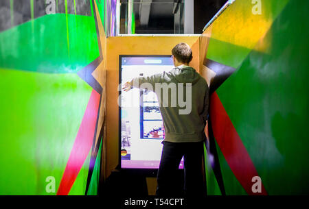 Berlin, Germany. 10th Apr, 2019. A young man walks through the exhibition 'Nineties Berlin' in the Alte Münze. Credit: Britta Pedersen/dpa-Zentralbild/dpa/Alamy Live News Stock Photo