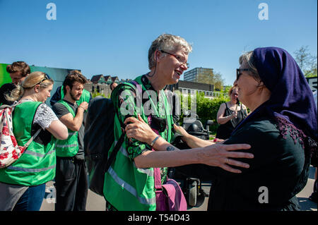 Rotterdam, South Holland, Netherlands. 20th Apr, 2019. Two activists are seen embracing each other before the demonstration.A funeral procession was carried out by the international movement, Extinction Rebellion in Rotterdam. With this action, the movement is demanding the Dutch government to declare a Climate Emergency act on making a Delta Plan Climate for Rotterdam, ZERO net emissions of CO2 in 2025, including the Port of Rotterdam. Credit: Ana Fernandez/SOPA Images/ZUMA Wire/Ģ����ý Live News Stock Photo