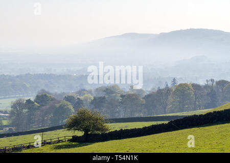 Yorkshire, UK. 21st April 2019.  Wharfedale valley under smoke.  Often a beautiful mist fills the Wharfedale valley as the sun rises but this morning, it is smoke-filled after a wildfire causing untold damage to wildlife on Ilkley Moor. Credit: Rebecca Cole/Alamy Live News Stock Photo