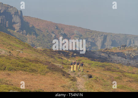 Yorkshire, UK. 21st April 2019.  Fire services continue efforts to extinguish fire on Ilkley Moor after working overnight.  New shift of firefighters look over to the smouldering moors they are about to tackle. Credit: Rebecca Cole/Alamy Live News Stock Photo