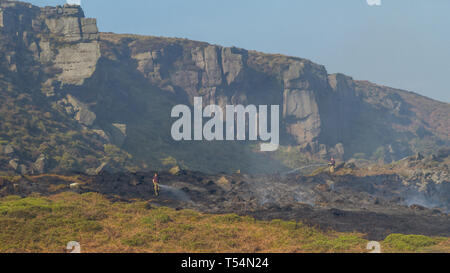 Yorkshire, UK. 21st April 2019.  Firefighters continue efforts to extinguish fire on Ilkley Moor after working overnight. Fire crew first thing this morning still with water jets trying to extinguish the wildfire completely.  Rebecca Cole/Alamy Live News Stock Photo