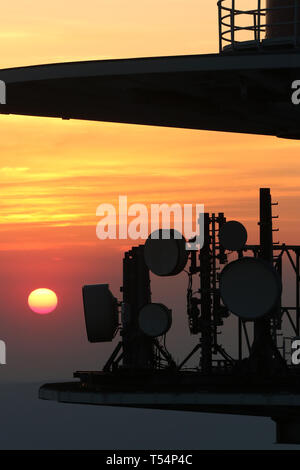 18 April 2019, Saxony-Anhalt, Schierke: In the light of the setting sun, the antenna systems on the Brocken can be seen. Photo: Matthias Bein/dpa-Zentralbild/dpa Stock Photo