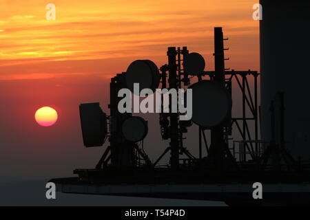 18 April 2019, Saxony-Anhalt, Schierke: In the light of the setting sun, the antenna systems on the Brocken can be seen. Photo: Matthias Bein/dpa-Zentralbild/dpa Stock Photo