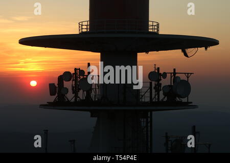 18 April 2019, Saxony-Anhalt, Schierke: In the light of the setting sun, the antenna systems on the Brocken can be seen. Photo: Matthias Bein/dpa-Zentralbild/dpa Stock Photo