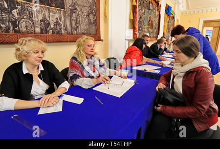 Kiev, Ukraine. 21st Apr, 2019. Staff members check informations for a voter at a polling station in Kiev, Ukraine, April 21, 2019. Ukrainians began to cast their ballots on Sunday in a second round of the country's presidential election between actor Volodymyr Zelensky and incumbent President Petro Poroshenko. Credit: Chen Junfeng/Xinhua/Alamy Live News Stock Photo