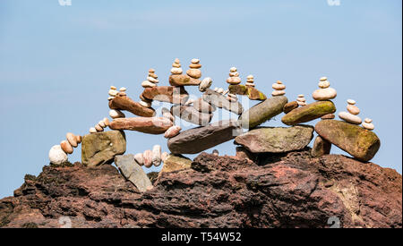 Dunbar, East Lothian, Scotland, UK. 21st Apr 2019. European stone stacking championship: Stone balance by Pedro Duran, from Spain and overall winner of last year's competition in the artistic competition, giving competitors 3 hours to create anything from stones or found objects  competition at Eye Cave beach Stock Photo