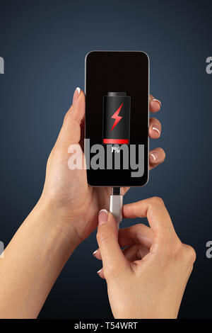 Elegant hand charging cellphone with low battery  Stock Photo