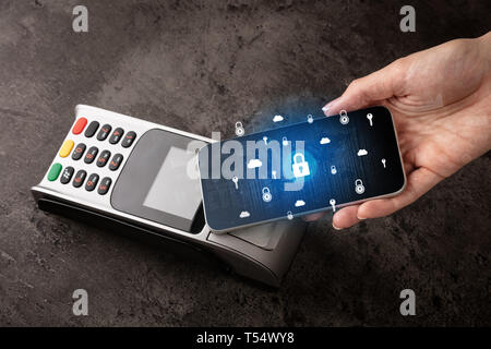 Hand paying with cellphone on POS, secure payment concept  Stock Photo