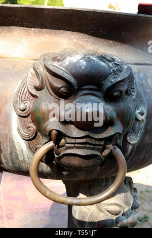 Singha statue on old joss stick pot ncense burner. Stock Photo