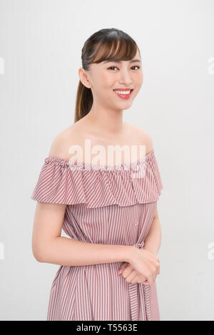 Pretty smiling joyfully asian teenager female dressed casually, looking with satisfaction at camera Stock Photo