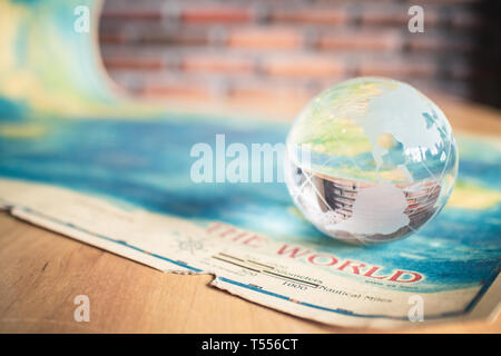 crystal globe on world map Stock Photo