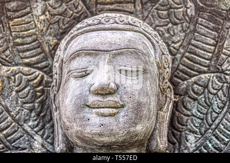 This unique photo shows the head of a beautiful Buddha statue made of stone. This photo was taken in Hua Hin in Thailand Stock Photo