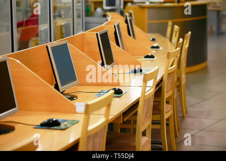 Wooden tables and many computers. Equipped with computer equipment class. Stock Photo