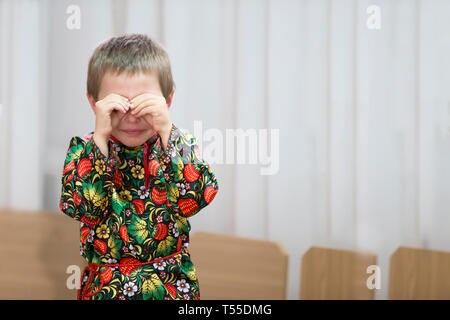 The little boy is crying.Kid covered his face with his hands Stock Photo