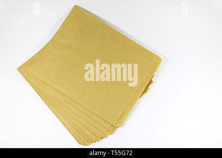 Stack of reusable, recyclable and biodegradable brown paper bags set on a white background. An alternative to plastic packaging Stock Photo