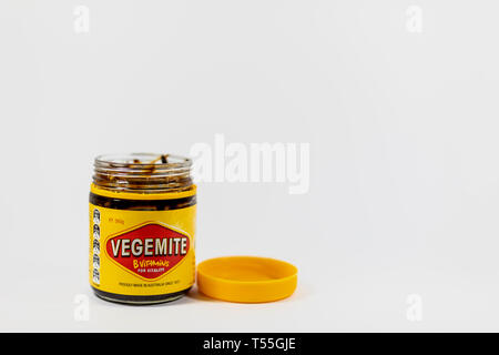 An opened jar of Vegemite, isolated on a white background Stock Photo