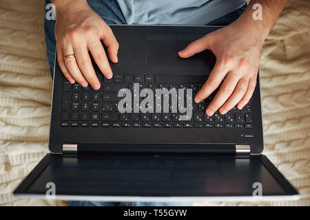 a man works on a laptop, a freelancer develops new goals. Stock Photo