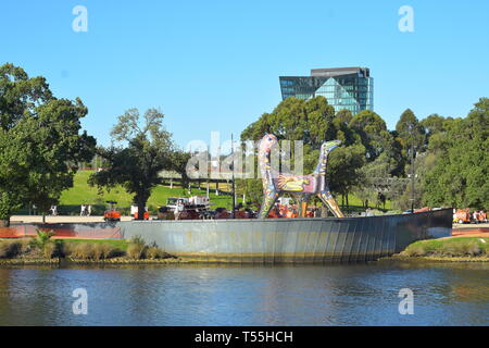 Calm waters of Yarra River in Melbourne reflecting park greenery and Angel the Mosaic Sculpture on sunny early summer day. Stock Photo