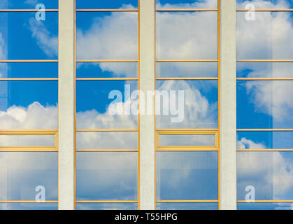 beautiful urban architecture background. window reflection of a clouds on a blue sky Stock Photo