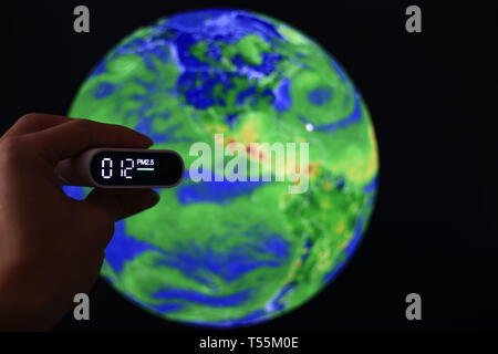 measuring air quality. particulate matter 2.5 (pm.2.5) sensor. harmful small dust detector indicated healthy acceptable air quality. blur background o Stock Photo