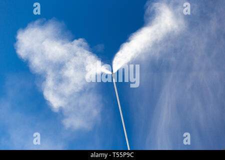 Snow cannon gun or machine sprays water and snowes a ski or cross-country  track Stock Photo - Alamy