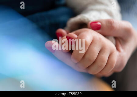 Mother and daughter holding hands Stock Photo