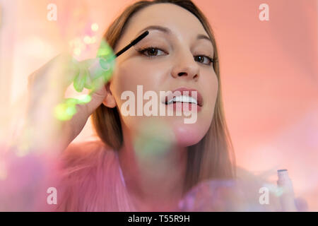Young woman applying mascara Stock Photo