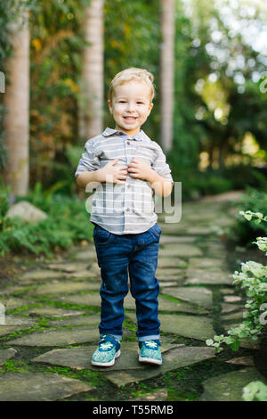 Smiling boy standing in garden Stock Photo