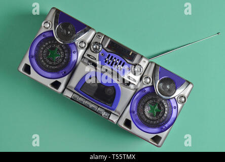 Retro tape recorder on mint-colored pastel background. Technology 80s. Top view. Stock Photo