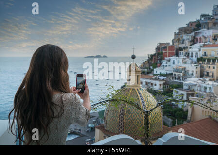 Woman taking photograph using smart phone in Positano, Italy Stock Photo