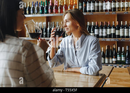 Young women drinking red wine Stock Photo