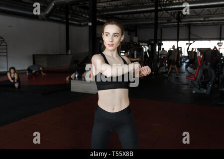 Young woman stretching in gym Stock Photo